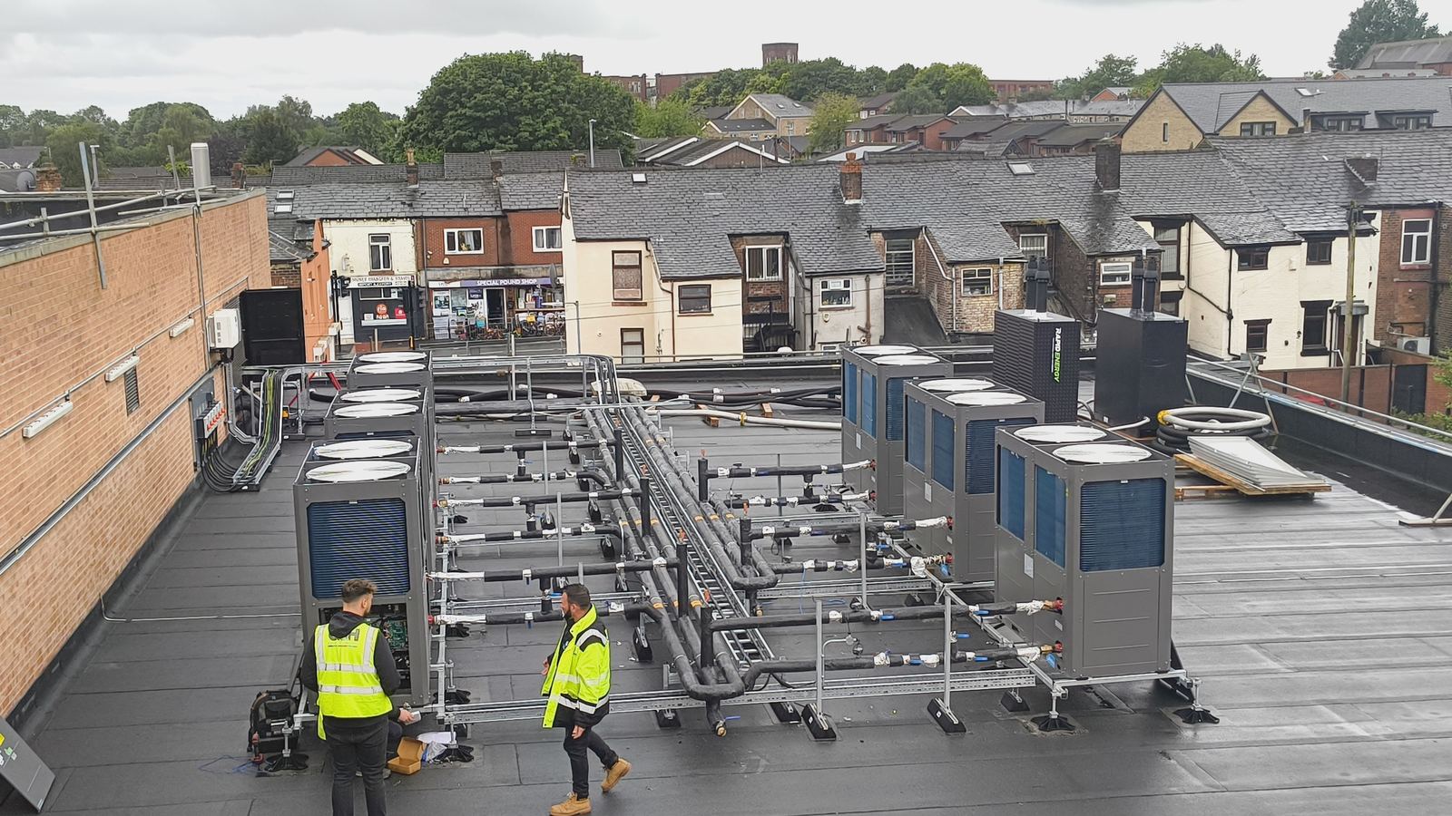 Jupiter engineers on a roof with a completed air source heat pump array